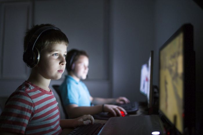Boys gaming on PCs